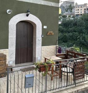 a building with a door and a table and chairs at Casa Vacanze Il Vicolo - Oliveto Citra in Oliveto Citra