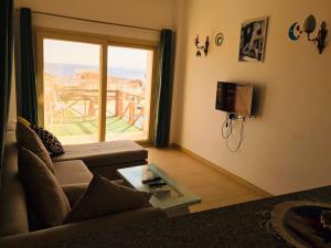 a living room with a couch and a sliding glass door at Dahab Hills Resort in Dahab