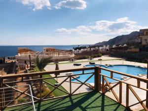 a view from the balcony of a resort with a swimming pool at Dahab Hills Resort in Dahab
