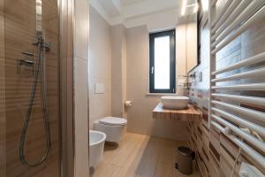 a bathroom with a toilet and a sink and a shower at The Garden in Canistro +28 photos