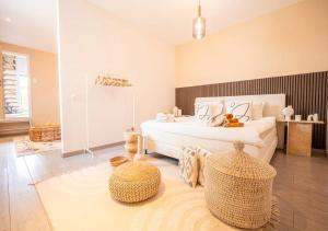 a bedroom with a bed and two ottomans at Calya Family Home in Brussels - 4 Bedrooms in Sint-Pieters-Leeuw