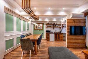 a dining room with a table and chairs and a tv at Maniz Apart in Istanbul