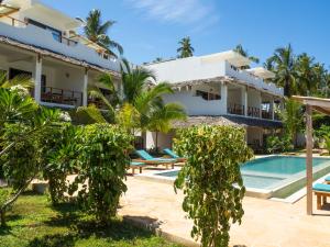 a villa with a swimming pool and a resort at Pingwe Beach Apartments in Pingwe
