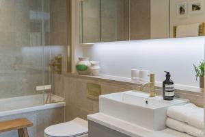 a bathroom with a white sink and a shower at Shoreline Beach House by Bloom Stays in Folkestone +37 photos