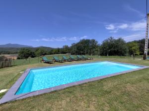 an image of a swimming pool in the grass at Casa rural Ca l'Antón in Sant Miquel de Campmajor