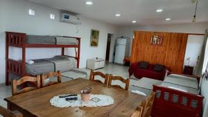 a room with a table and a dining room with bunk beds at Alojamiento Caroya in Colonia Caroya