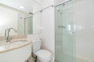 a bathroom with a toilet and a glass shower at Vision Hotel em Brasília 60613 in Brasília
