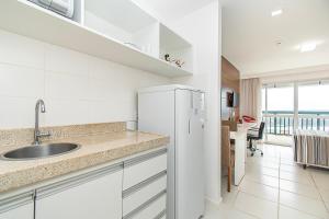 a white kitchen with a sink and a refrigerator at Vision Hotel em Brasília 60613 in Brasília +28 photos