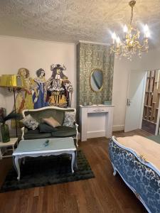 a room with a bed and a couch and a chandelier at Domaine du Rosiere in Favières +40 photos