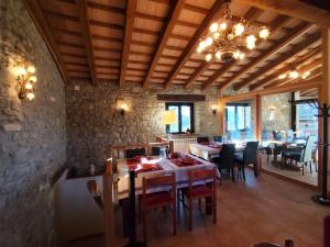a dining room with tables and chairs in a building at Casa rural Ca l'Antón in Sant Miquel de Campmajor