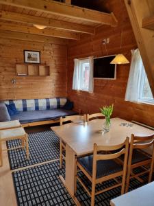 a living room with a table and a couch at Feriebyens Camping in Rødvig