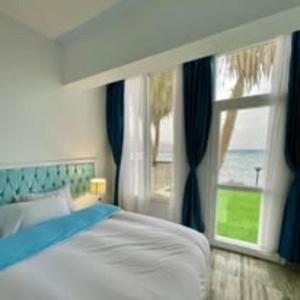 a bedroom with a bed and a large window at ايارو نوب-iaru nub in Dahab +39 photos