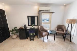 a room with a desk and chairs and a mirror at Nile View Inn in Cairo