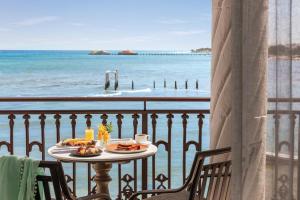a table with food on a balcony with the ocean at Wyndham Alltra Playa del Carmen Adults Only All Inclusive in Playa del Carmen +125 photos