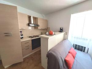 a small kitchen with a sink and a stove at Chardon in Le Mas