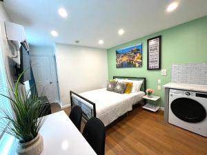 a small room with a bed in a green wall at New! Suite near Rittenhouse Square in Philadelphia