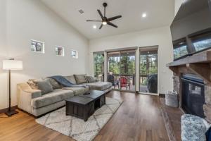 a living room with a couch and a fireplace at Scenic Golf Retreat with Modern Comforts & Fireplace townhouse in Show Low