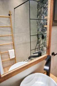 a bathroom with a toilet and a mirror at The Grandma's house in Artemida +39 photos