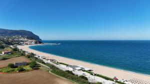 a beach with a bunch of cars parked on it at M080 - Marcelli, residence Mare Verde trilo con giardino in Marcelli