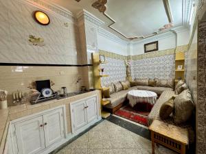 a living room with a couch and a table at Dar Yassine in Rabat