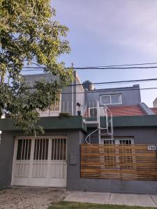 a house with a wooden fence in front of it at Apartamento Paracao in Paraná