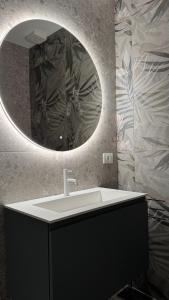 a bathroom with a sink and a mirror at La Ghiaia in Verona