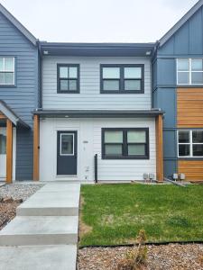 a house with a blue and white at Stanley Townhomes by StayIn in Radium Hot Springs