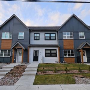 a large house with a gray at Stanley Townhomes by StayIn in Radium Hot Springs