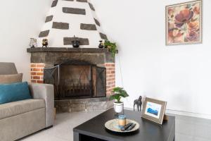 a living room with a couch and a fireplace at Mosteiros Coastal Haven in Mosteiros