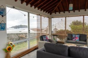a living room with a view of the ocean at Mosteiros Coastal Haven in Mosteiros +16 photos