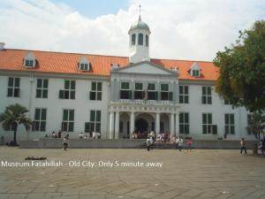 a large white building with a tower on top of it at Twins Hotel in Jakarta