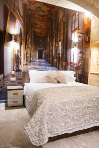 a bedroom with a large white bed in a room at Valletta City Suites in Valletta