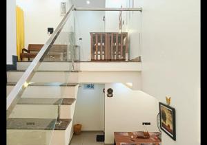 a glass staircase in a house at Pepper Jazz Varkala in Varkala
