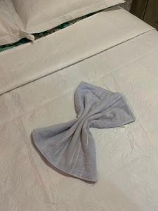 a blanket on a bed with a dress on it at Casa de temporada sonho de verão in Piranhas