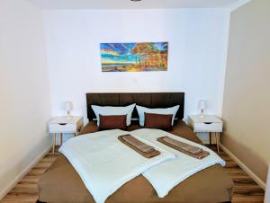 a bedroom with a large bed with two night stands at Panorama-Meerblick am Scharbeutzer Strand in Scharbeutz +20 photos