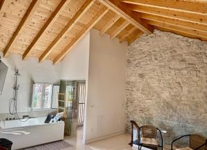 a living room with a stone wall and a sink at Villa Tité in Oviedo