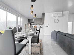 a dining room and kitchen with a table and chairs at Modern Retreat in San Miguel