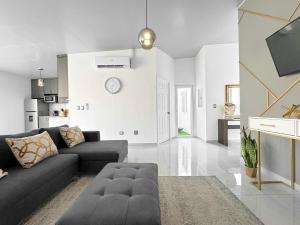 a living room with a couch and a tv at Modern Retreat in San Miguel