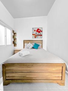 a bedroom with a large bed with a wooden frame at Modern Retreat in San Miguel