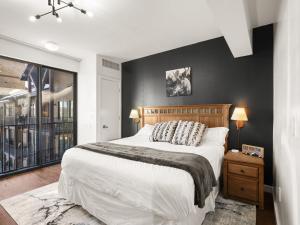 a bedroom with a large bed and a black wall at Top Floor Deer Valley Gondola Lakefront Condo- Great views in Heber City