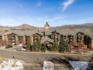 a large building with a clock tower on top of it at Top Floor Deer Valley Gondola Lakefront Condo- Great views in Heber City