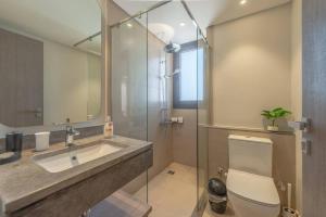 a bathroom with a sink and a toilet and a shower at Stylish 3 BR Retreat at Ancient Hills El Gouna in El Gouna +36 photos