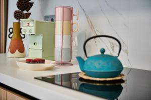 a kitchen counter with a teapot and a blender at The Grandma's house in Artemida