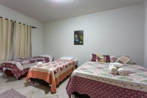 a bedroom with two beds in a room at Pousada Pé de Cedro in Bonito