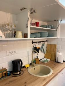 a kitchen counter with a sink in a kitchen at Sleepover Galleria in Novi Sad