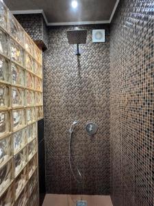a bathroom with a shower with a shower head at Chernihiv City Apartments - Peremohy in Chernihiv +41 photos