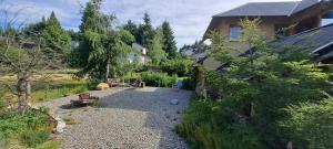 a backyard of a house with a gravel yard at Casa Nico in San Carlos de Bariloche
