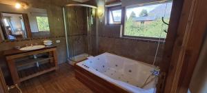a large bathroom with a tub and a sink at Casa Nico in San Carlos de Bariloche