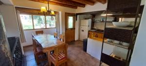 a kitchen with a wooden table in a room at Casa Nico in San Carlos de Bariloche +4 photos