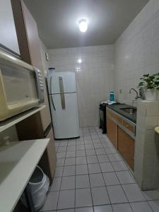 a kitchen with a refrigerator and a sink at Cê Achegue Aqui Uai in Contagem
